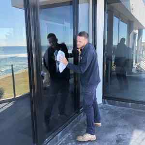 Our glazier doing an emergency door glass replacement in Coogee NSW